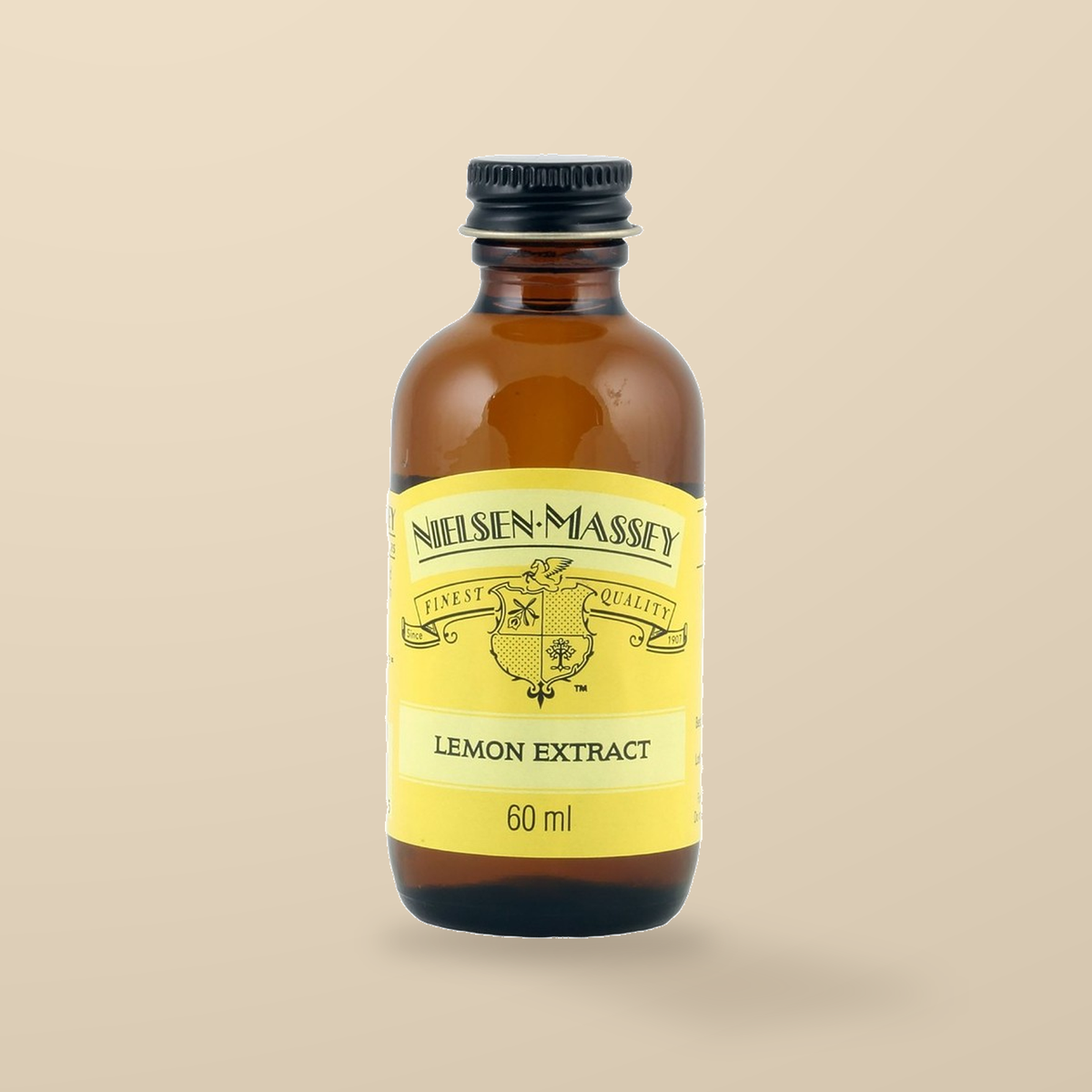 Nielsen-Massey Pure Lemon Extract – 60ml — original product packaging on warm beige background