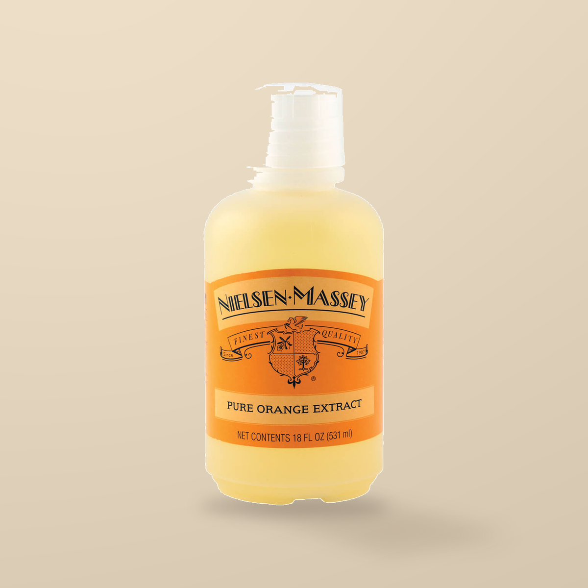 Nielsen-Massey Pure Orange Extract – 530ml — original product packaging on warm beige background