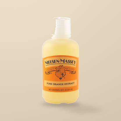 Nielsen-Massey Pure Orange Extract – 530ml — original product packaging on warm beige background