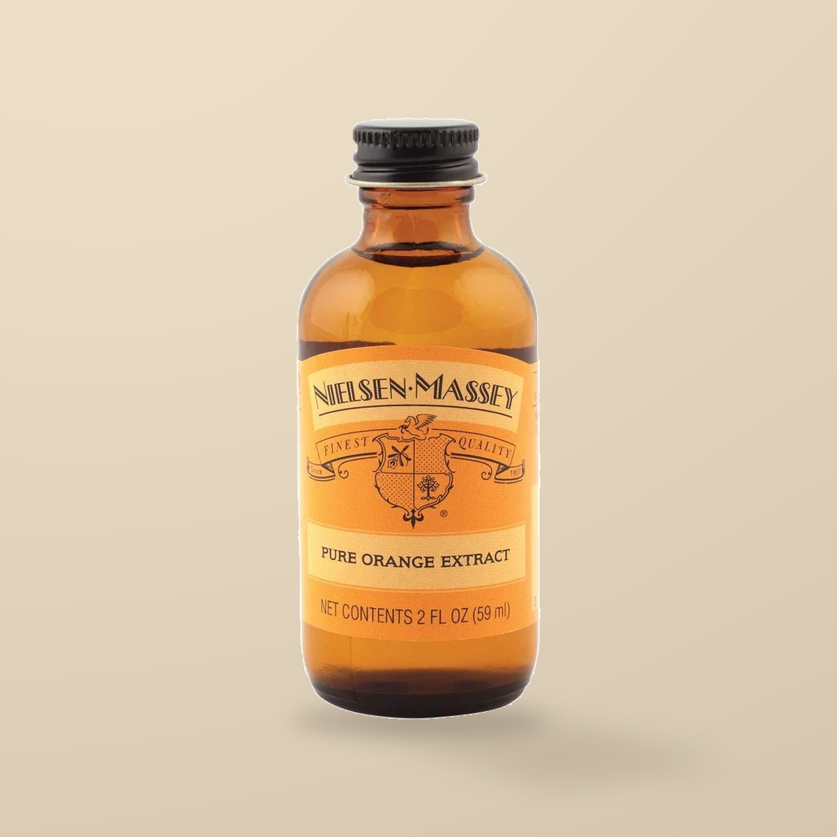 Nielsen-Massey Pure Orange Extract – 60ml — original product packaging on warm beige background