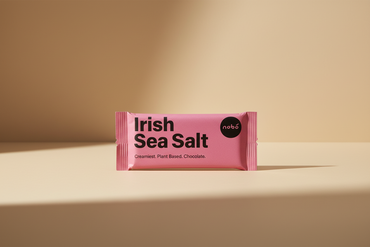 A pink foil wrapper for nobó Irish Sea Salt chocolate, featuring bold black text and a black circular logo on a white background.