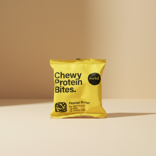 A bright yellow bag of nobó Chewy Protein Bites in Peanut Butter flavor, featuring bold black text and a small clear window showing the protein bites inside.