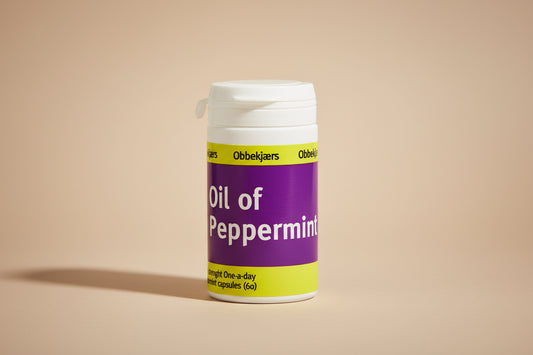Bottle of Oil of Peppermint capsules with purple label on a white background