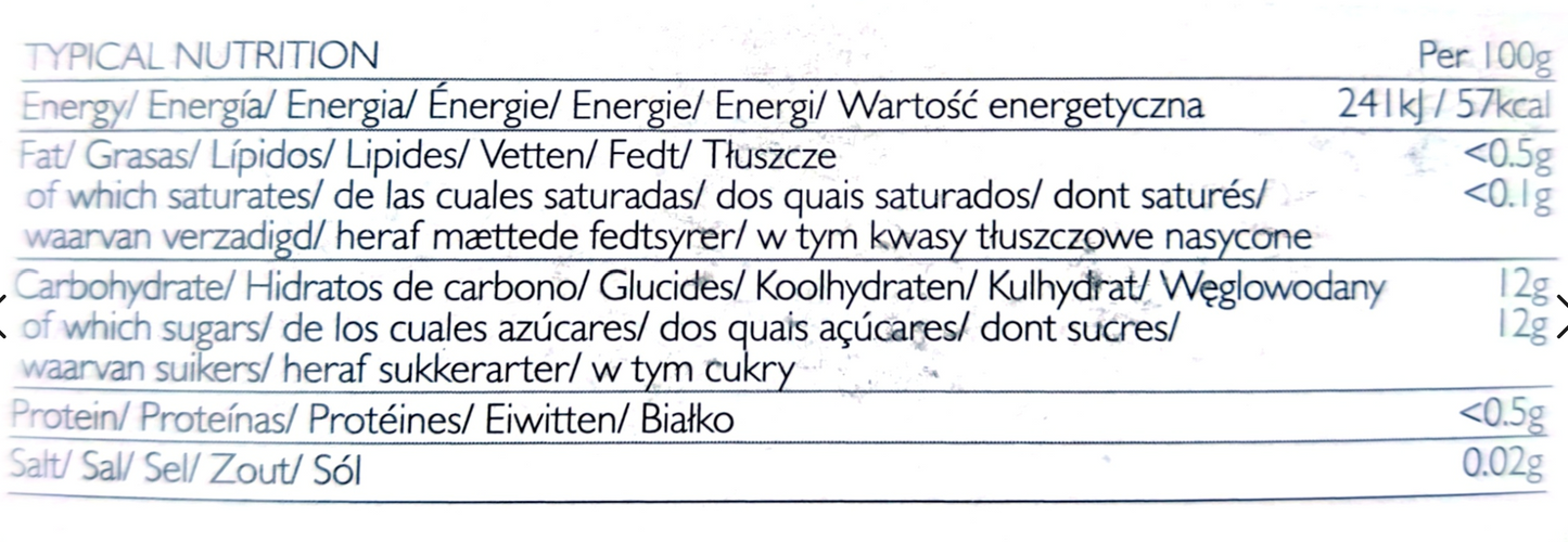 A close-up of a nutrition label table in Spanish, showing typical nutrition per 100g with energy, fats, carbohydrates, proteins, and salt amounts.