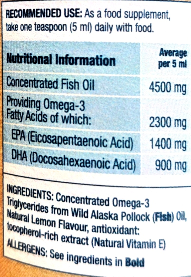 Close-up of a supplement label showing recommended use and nutritional information for concentrated fish oil, including omega-3 and fatty acid amounts per 5 ml.