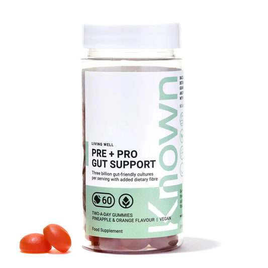 "Front view of Known Pre+Pro Gut Support Gummies VEGAN, 60-count bottle with a couple of gummies around it."