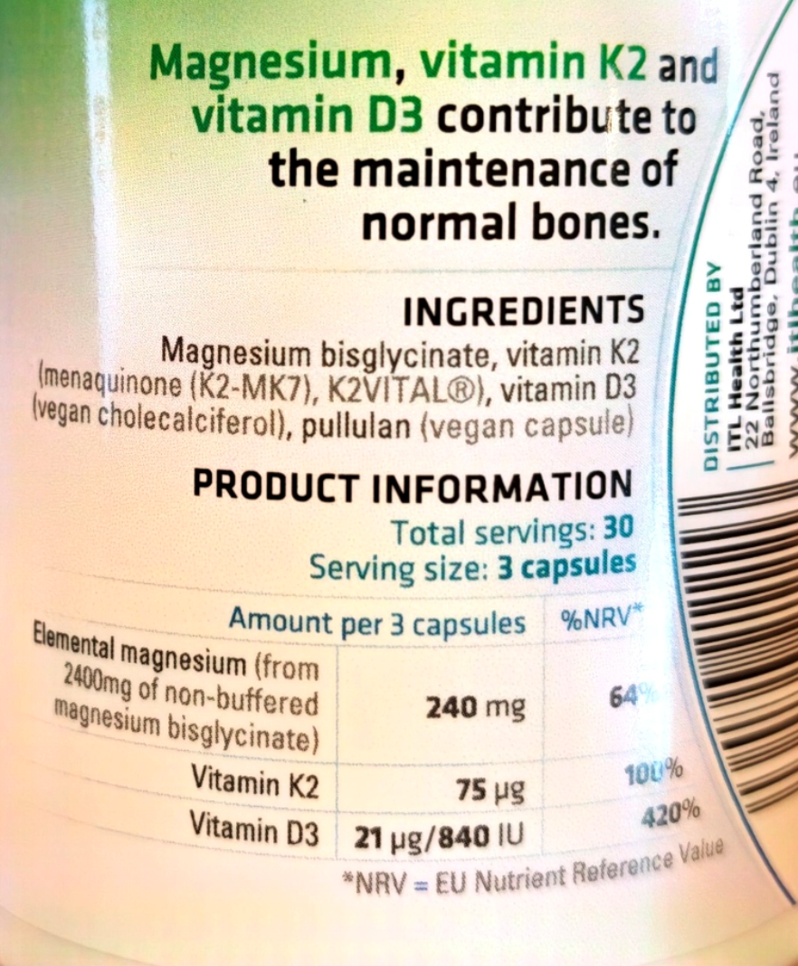 Close-up of a supplement bottle label showing text about magnesium, vitamin K2, and vitamin D3 for bone maintenance, with ingredients and product information including 'Total servings: 30' and 'Serving size: 3 capsules'.