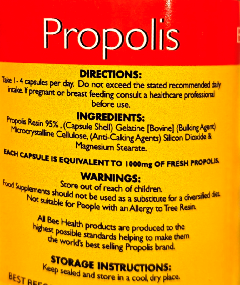 Close-up of a yellow and red supplement label for Propolis capsules, showing directions, ingredients, warnings, and storage instructions.