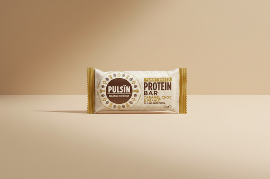 Pulsin' protein bar packaging with caramel choc & peanut flavor on a white background