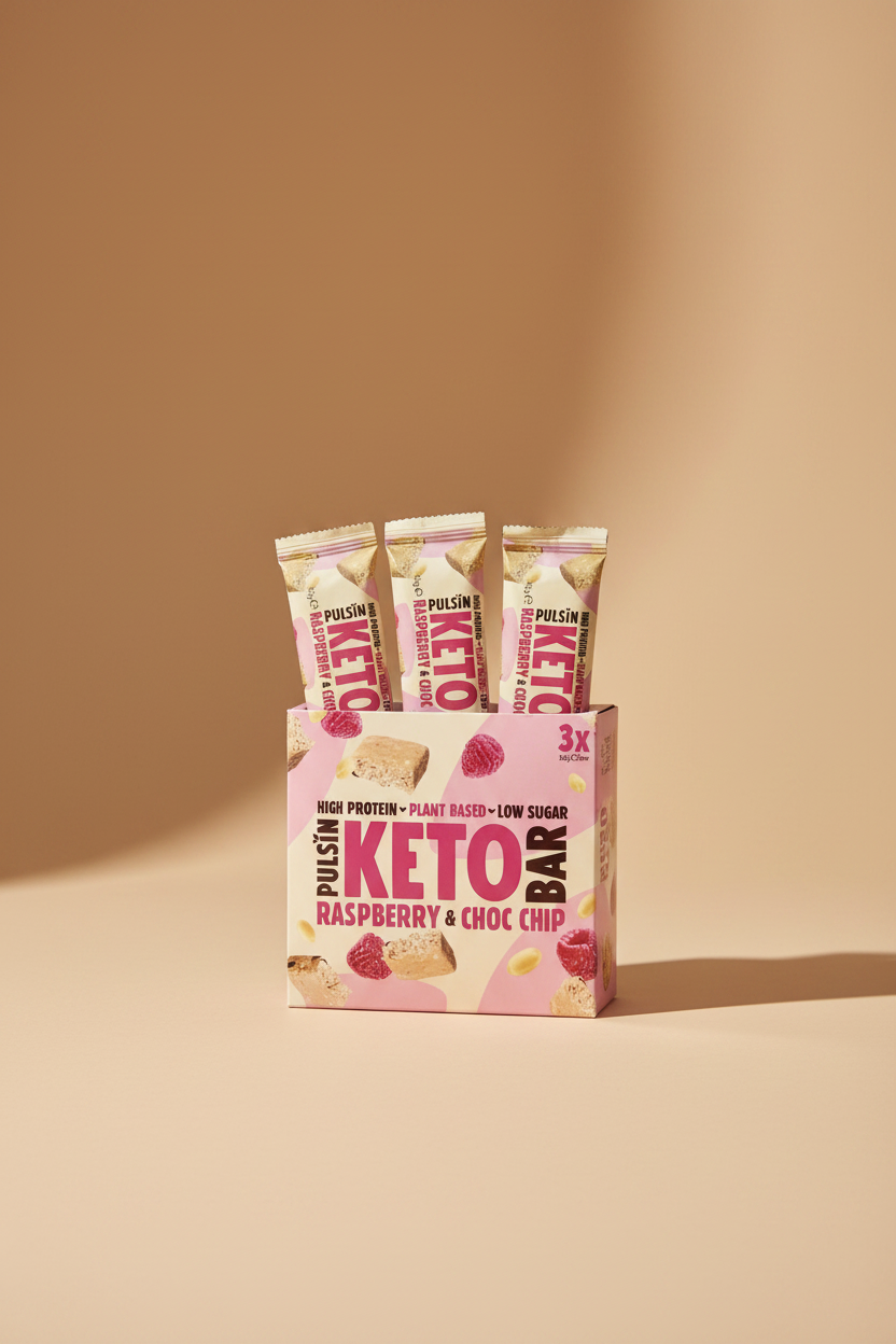 Pulsin' Keto Raspberry & Choc Chip bars packaging on a pink background