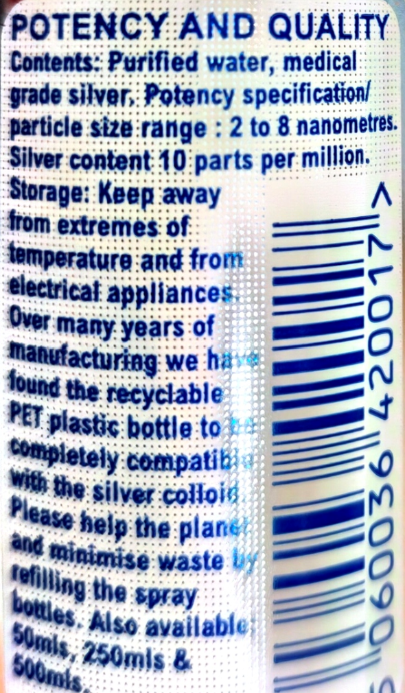 Close-up of a silver spray bottle label with blue text detailing contents, potency, storage instructions, and a vertical barcode.