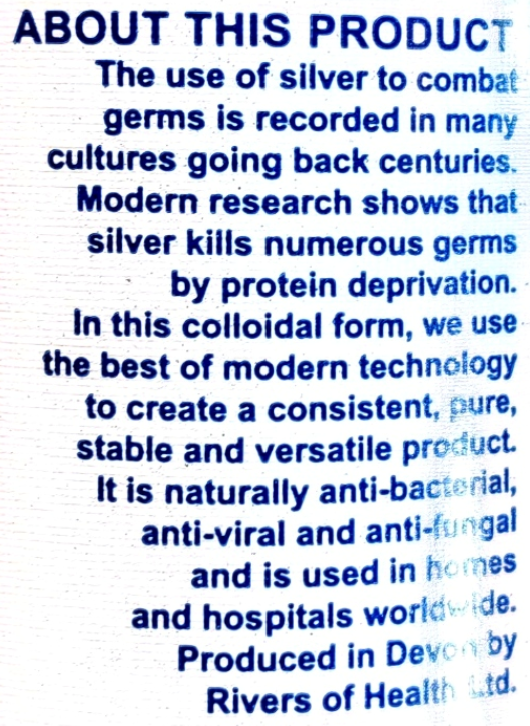 A close-up of a white textured surface with blue printed text reading 'ABOUT THIS PRODUCT' followed by descriptive copy about silver-based germ-killing claims and production by Rivers of Health Ltd.