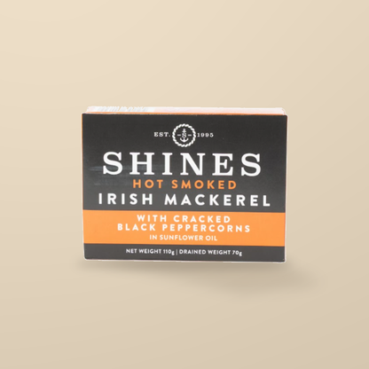 Shines Hot Smoked Irish Mackerel with Black Peppercorns – 110g — original product packaging on warm beige background