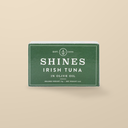 Shines Irish Albacore Tuna in Olive Oil – 111g — original product packaging on warm beige background