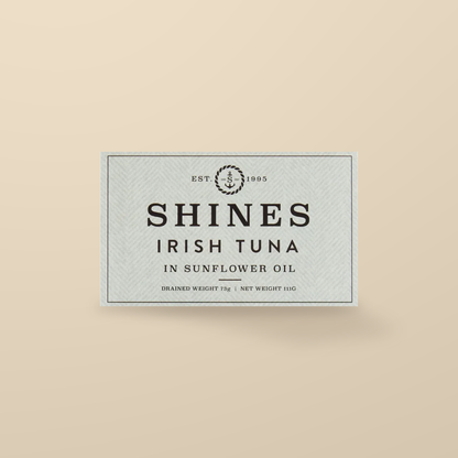 Shines Irish Albacore Tuna in Sunflower Oil – 111g — original product packaging on warm beige background