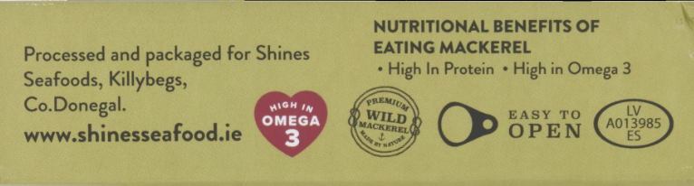 A close-up of a yellow-green product label with text about nutritional benefits of eating mackerel, processing and packaging by Shines Seafoods, Co.Donegal, a heart-shaped Omega 3 badge, and product codes.