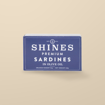 Shines Premium Sardines in Olive Oil – 118g — original product packaging on warm beige background