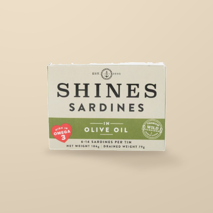 Shines Wild Irish Sardines in Olive Oil – 106g — original product packaging on warm beige background