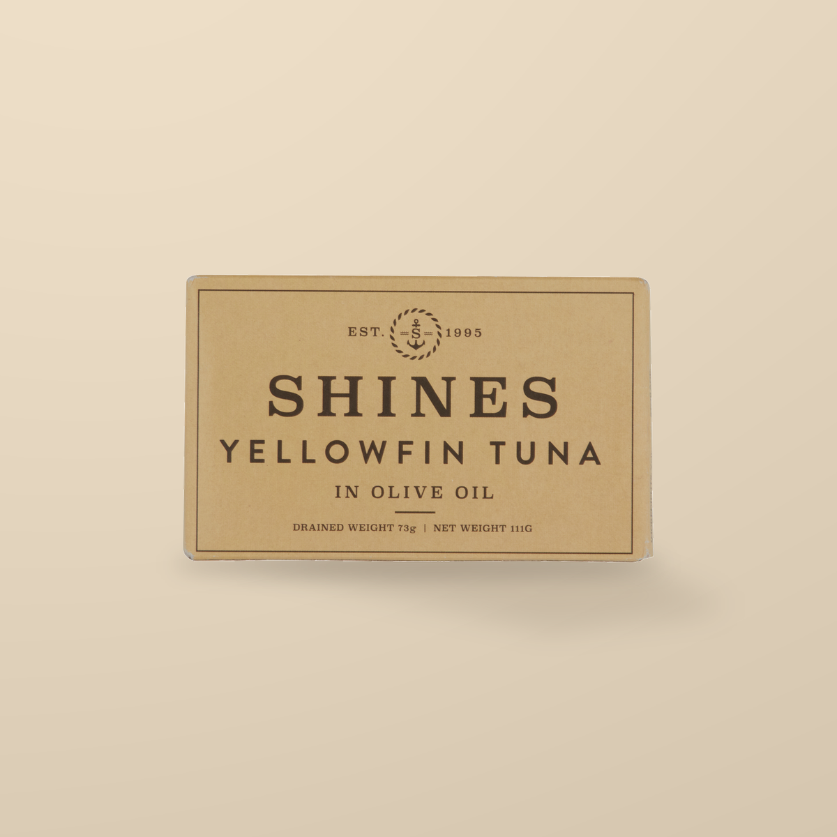 Shines Yellowfin Tuna in Olive Oil – 111g — original product packaging on warm beige background
