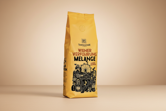 Yellow coffee bag with black text and graphics on a white background