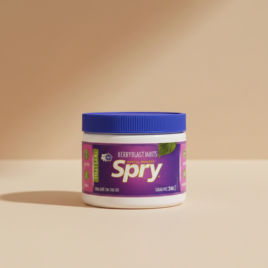 A white plastic jar of Spry Berryblast Mints dental defense mints with a blue screw-on lid and a purple label.
