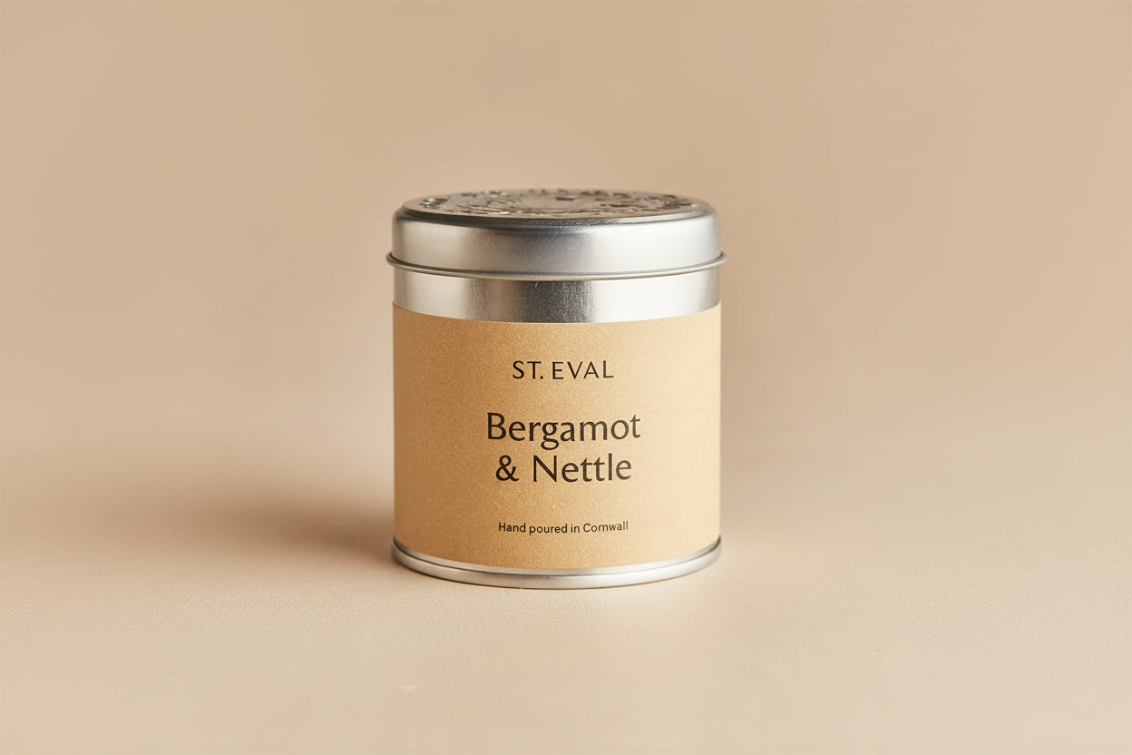 Candle tin labeled 'Bergamot & Nettle' by St. Eval on a light gray background