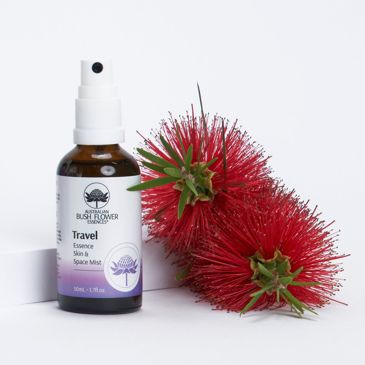 Australian Bush Flower Travel Mist 50ml beside red flowers