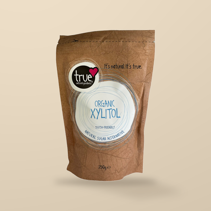 True Natural Goodness Organic Xylitol – 250g — original product packaging on warm beige background