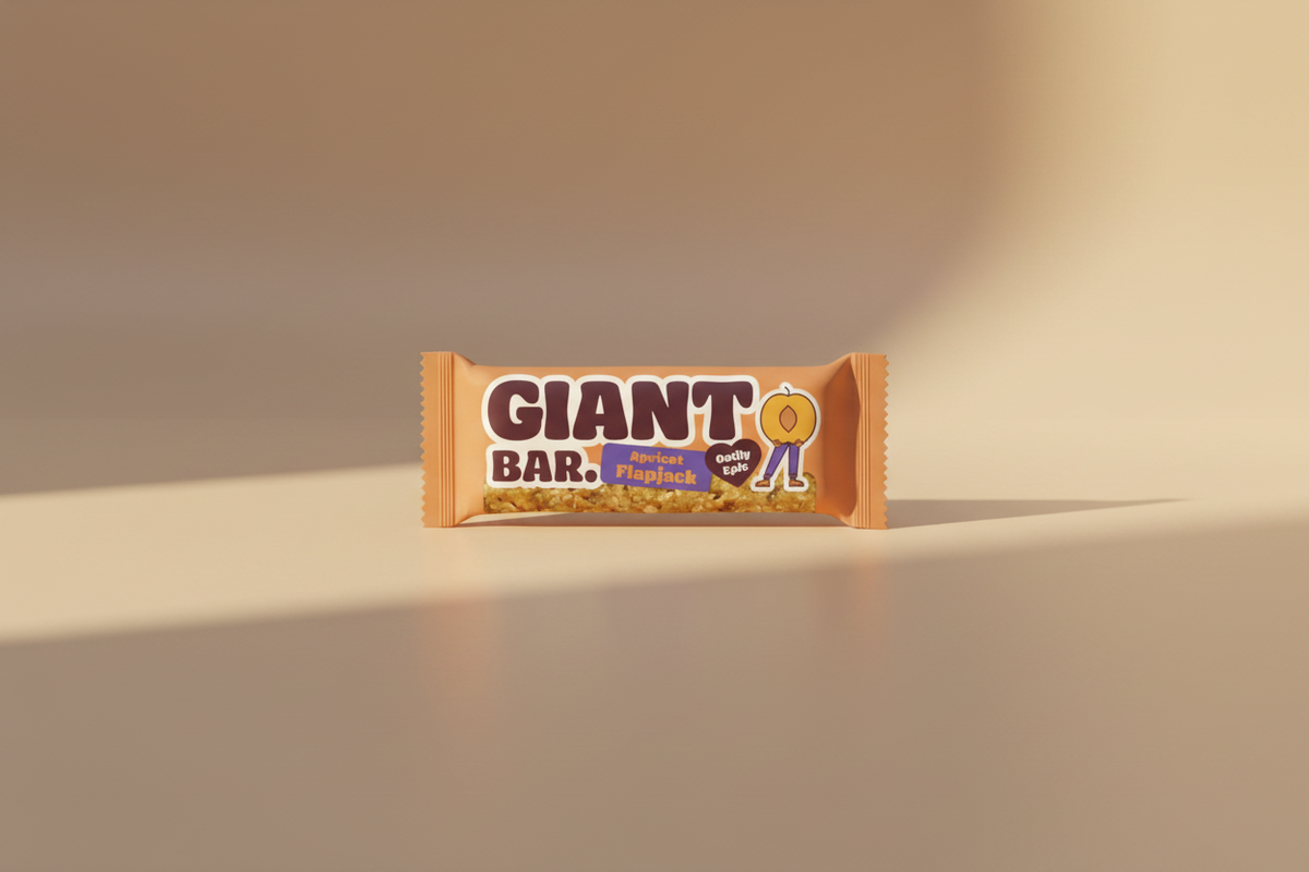 A packaged Giant Bar Apricot Flapjack snack bar on a plain white background. The wrapper is orange with large dark brown 'GIANT BAR.