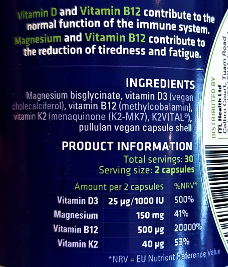 Close-up of a supplement bottle label showing ingredients and product information for a vitamin and magnesium capsule product. Visible text includes Vitamin D, Vitamin B12, magnesium, and product details such as total servings and serving size 2 capsules.