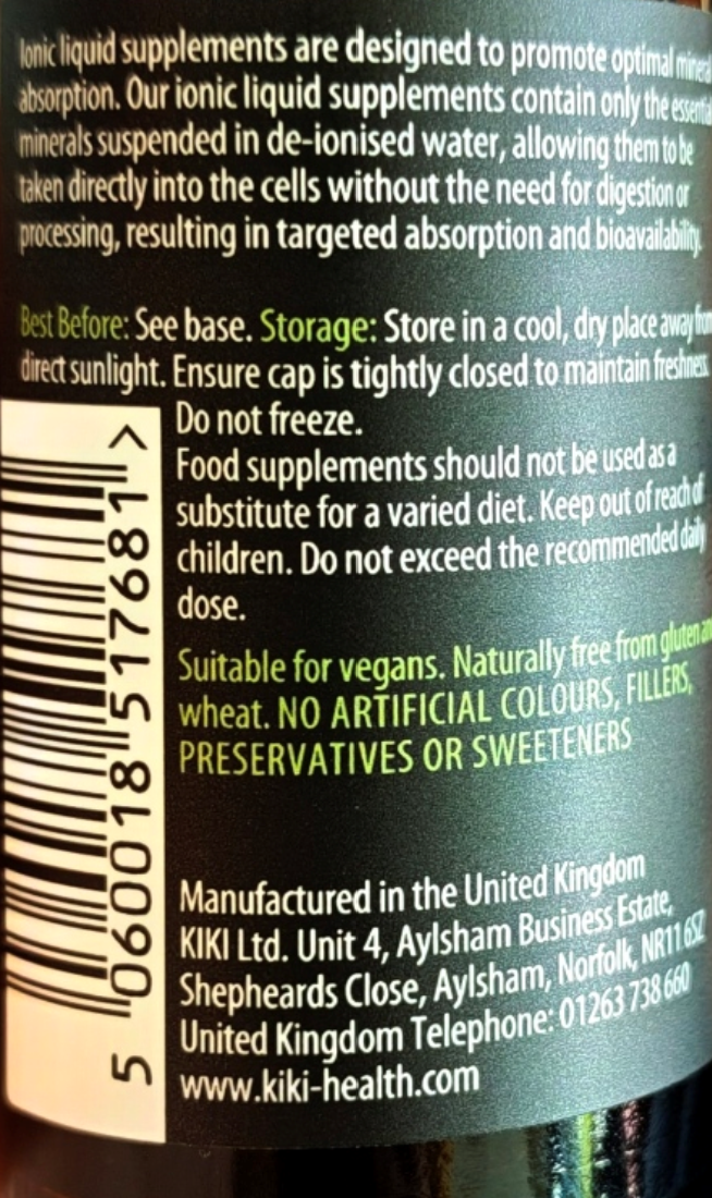 Close-up of the back of a Kiki Health ionic liquid supplement bottle showing product information, warnings, barcode, and manufacturing details on a dark green label.